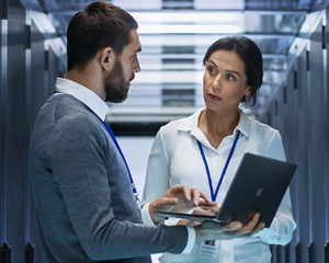 two cybersecurity professionals in a server room