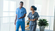 male and female nurses in scrubs talking