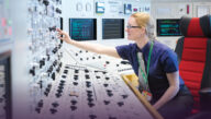 Technician operating a control board at a nuclear power plant