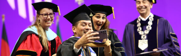 Graduate taking a selfie on stage