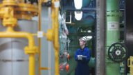 Nuclear technician checking safety gauges