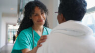 Smiling nurse showing a patient empathy, one of the common characteristics of a nurse